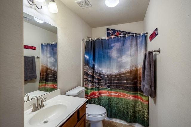 bathroom featuring vanity, toilet, a textured wall, and visible vents