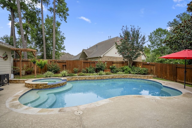 view of swimming pool with a patio area, a pool with connected hot tub, and a fenced backyard