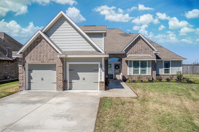 craftsman-style home featuring brick siding, a front lawn, roof with shingles, driveway, and an attached garage