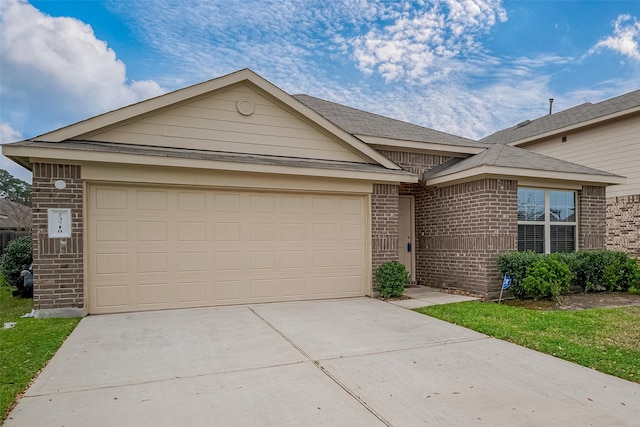 single story home with brick siding, an attached garage, and concrete driveway
