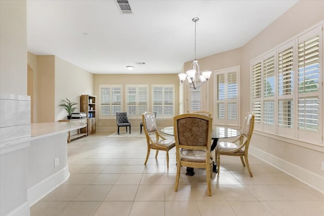 dining space featuring light tile patterned floors, visible vents, baseboards, and an inviting chandelier