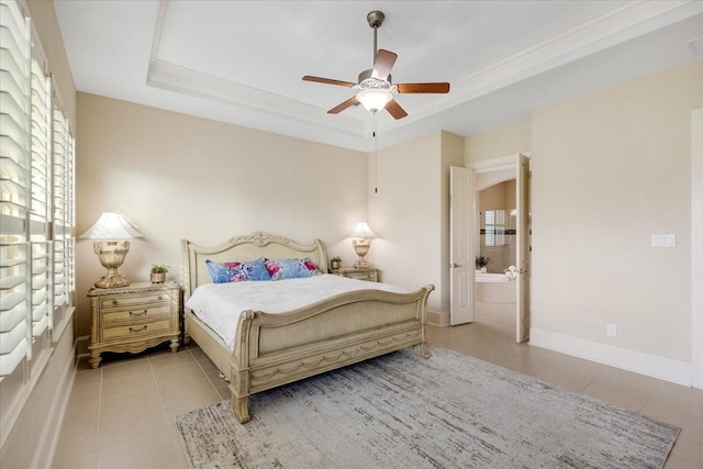 bedroom featuring light tile patterned floors, a tray ceiling, baseboards, and a ceiling fan