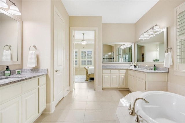 ensuite bathroom with tile patterned floors, two vanities, a sink, connected bathroom, and a bath