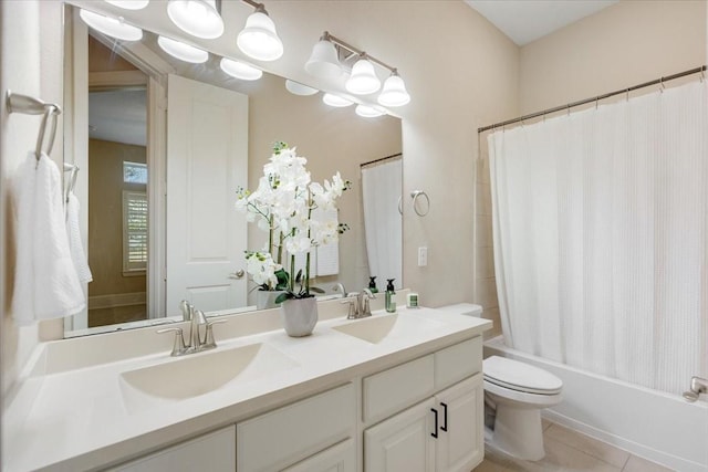 full bathroom featuring tile patterned flooring, shower / bath combination with curtain, toilet, and a sink