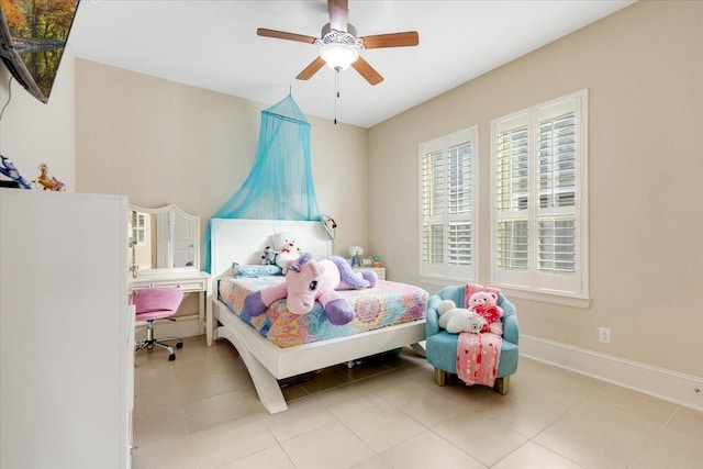 tiled bedroom featuring baseboards and ceiling fan