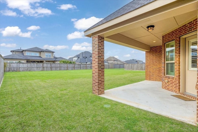 view of yard with a fenced backyard and a patio