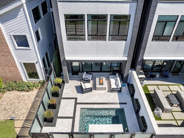 view of swimming pool featuring a patio and exterior kitchen