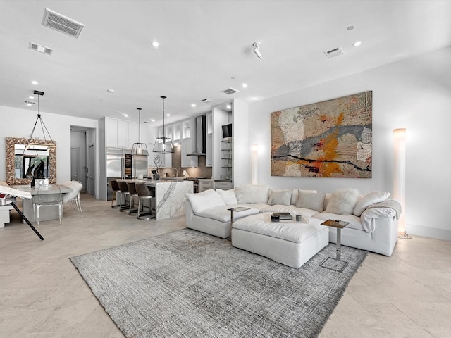 living room with recessed lighting and visible vents