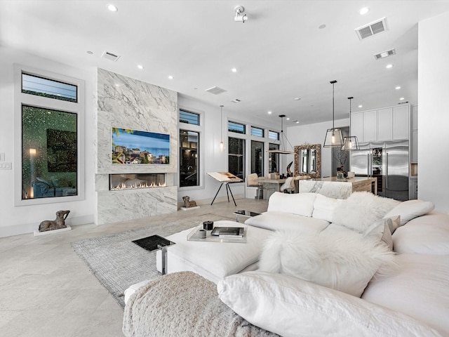 living area featuring recessed lighting and visible vents