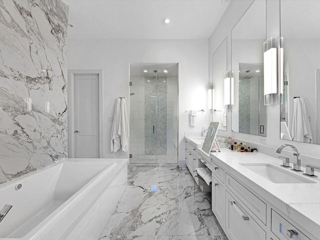 bathroom with a shower stall, a garden tub, recessed lighting, marble finish floor, and vanity