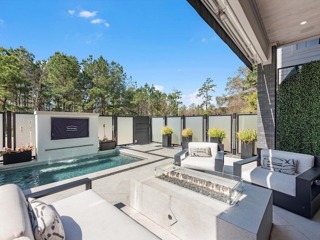 view of pool featuring an outdoor living space with a fire pit, fence, a patio area, and a fenced in pool