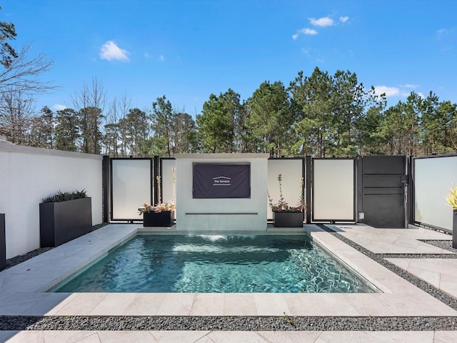 view of swimming pool featuring fence