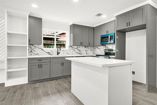 kitchen featuring open shelves, visible vents, gray cabinets, and stainless steel appliances