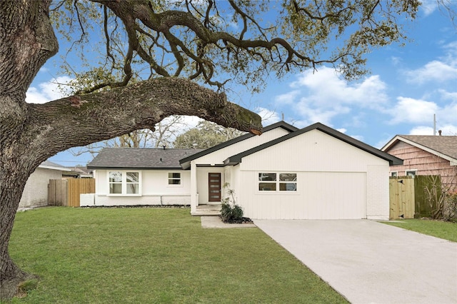 ranch-style home featuring a front yard, a gate, fence, driveway, and an attached garage