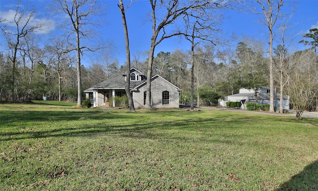 view of side of home featuring a yard and brick siding