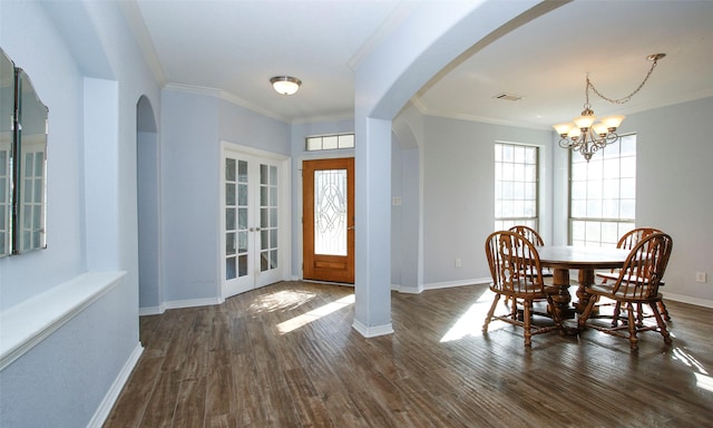 foyer with ornamental molding, visible vents, dark wood-style flooring, and baseboards