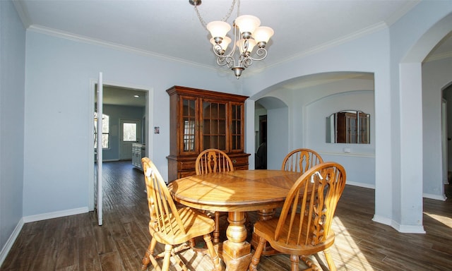 dining space with arched walkways, a chandelier, dark wood finished floors, and baseboards