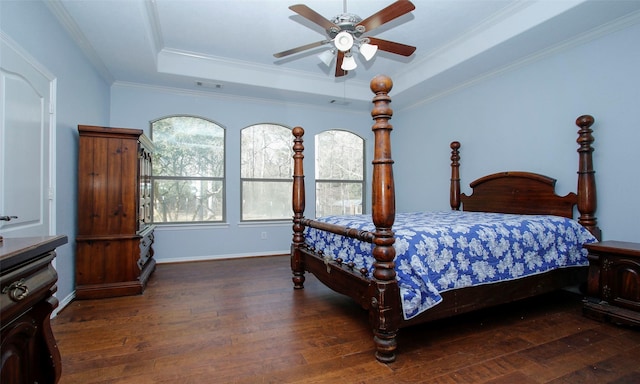 bedroom featuring visible vents, a raised ceiling, multiple windows, and wood-type flooring