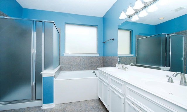 bathroom with a sink, visible vents, a bath, and a shower stall