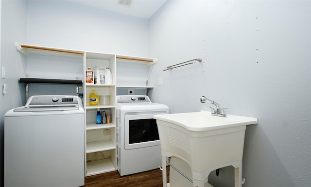 washroom with washer and dryer, dark wood-style flooring, laundry area, and a sink