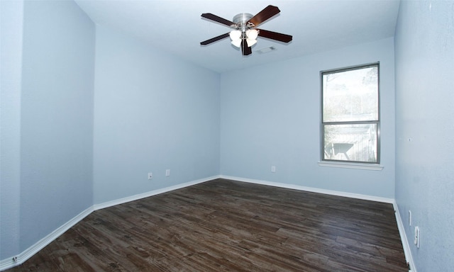 empty room with dark wood finished floors, baseboards, and ceiling fan