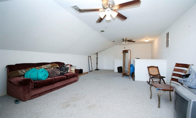 living area featuring carpet flooring, visible vents, and vaulted ceiling