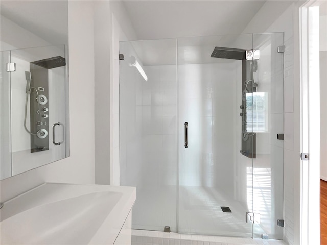 bathroom featuring a stall shower and vanity