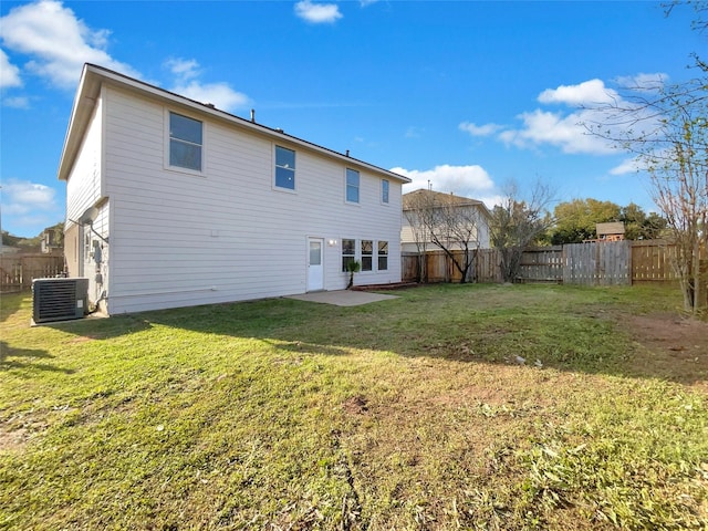 rear view of property featuring a fenced backyard, a lawn, and central AC