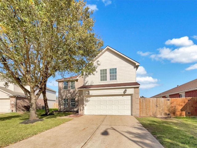 traditional-style house featuring brick siding, fence, a front yard, a garage, and driveway