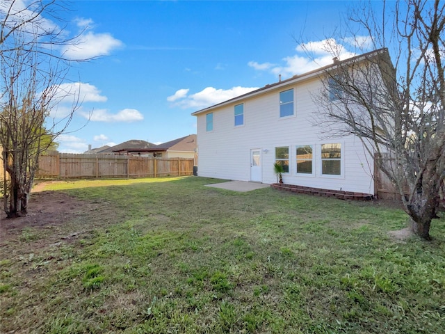 back of property with a lawn and a fenced backyard