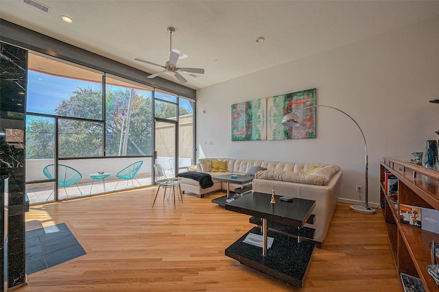 living room featuring recessed lighting, wood finished floors, visible vents, and a ceiling fan