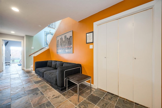 interior space featuring stone tile floors, recessed lighting, stairs, and baseboards