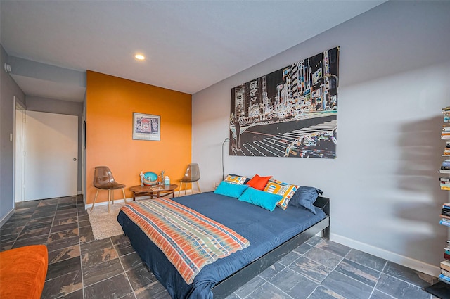 bedroom featuring recessed lighting, baseboards, and stone finish floor