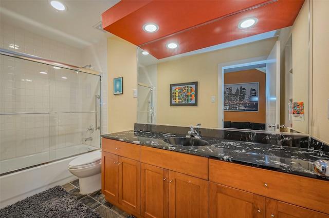 bathroom with vanity, enclosed tub / shower combo, toilet, visible vents, and recessed lighting