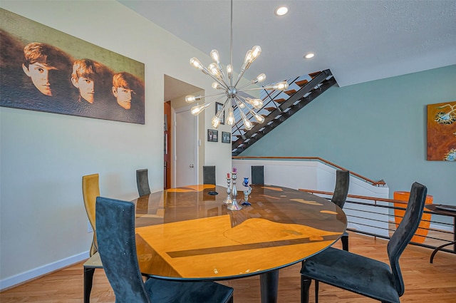 dining space with baseboards, recessed lighting, a chandelier, wood finished floors, and stairs