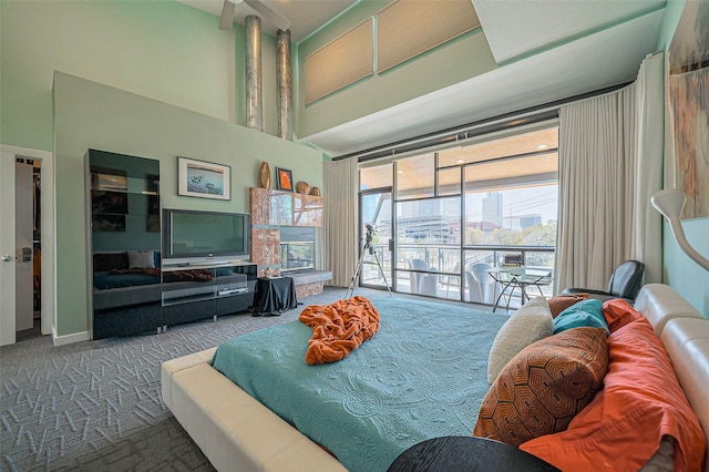 carpeted bedroom with a high ceiling