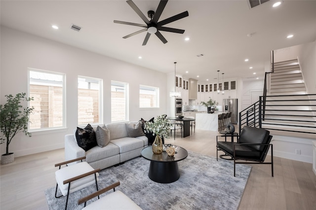 living area featuring light wood finished floors, plenty of natural light, recessed lighting, and a ceiling fan