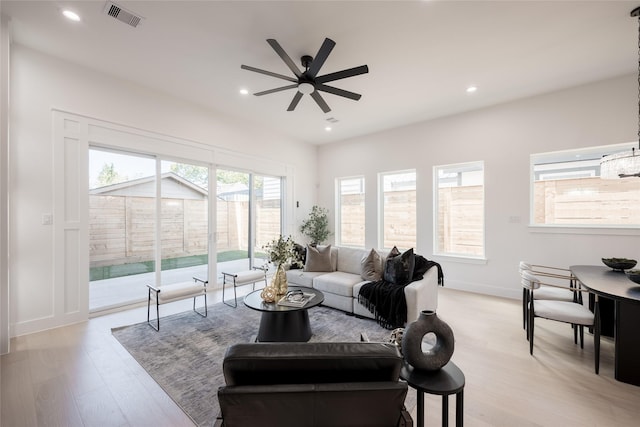 living area with light wood finished floors, visible vents, recessed lighting, and a ceiling fan