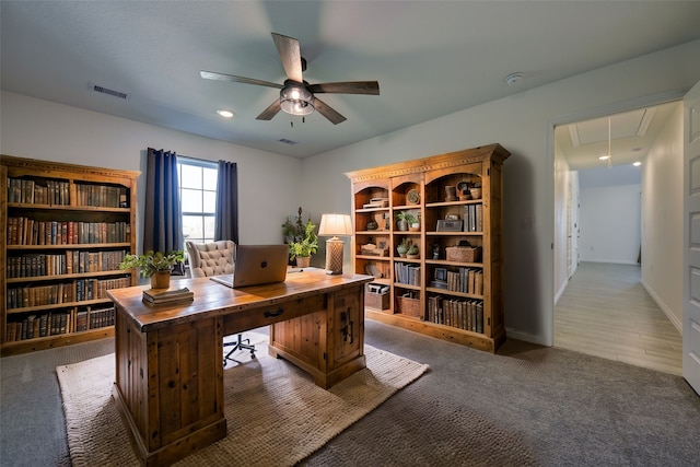 carpeted home office with a ceiling fan, visible vents, baseboards, attic access, and recessed lighting