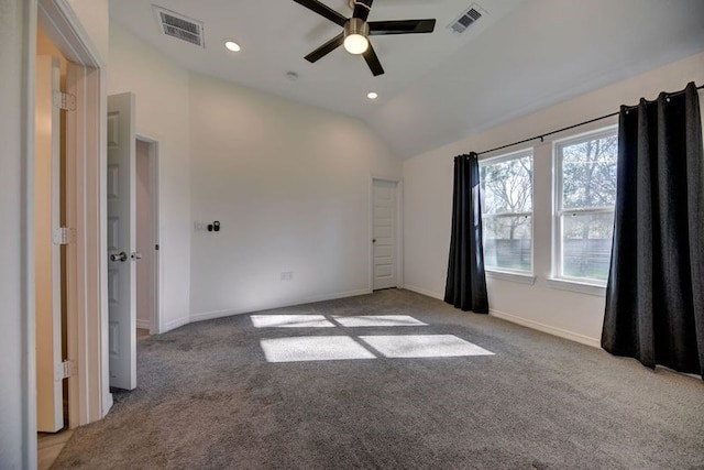 spare room with lofted ceiling, carpet, visible vents, and baseboards