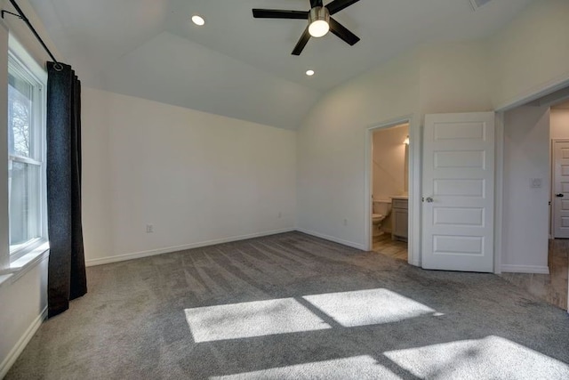 unfurnished bedroom with lofted ceiling, baseboards, and carpet floors