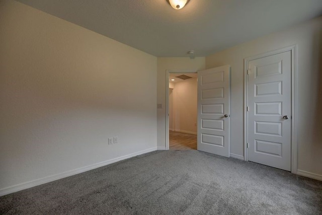 unfurnished bedroom with visible vents, baseboards, and carpet floors