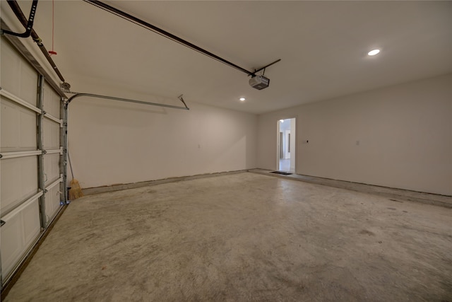 garage with recessed lighting and a garage door opener