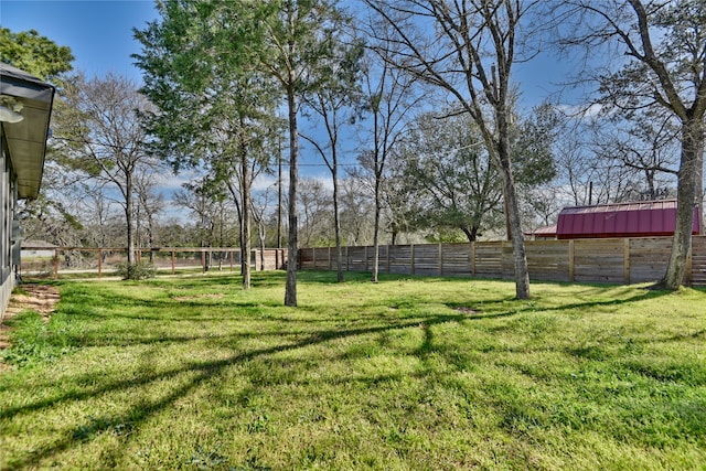 view of yard with an outbuilding and fence