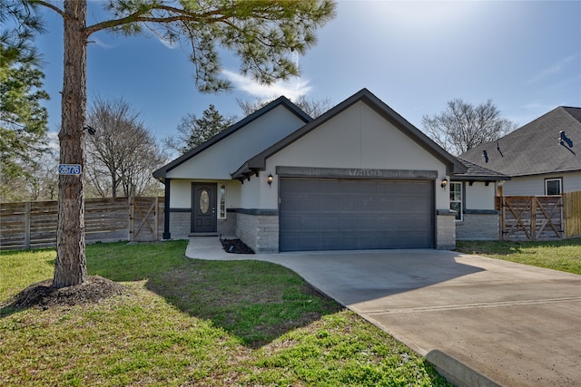 view of front of house featuring stucco siding, fence, concrete driveway, a front yard, and a garage