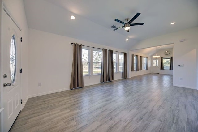 unfurnished living room featuring light wood finished floors, visible vents, baseboards, vaulted ceiling, and recessed lighting