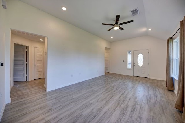 unfurnished living room with visible vents, light wood-type flooring, a ceiling fan, and vaulted ceiling