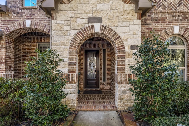 property entrance featuring brick siding and stone siding