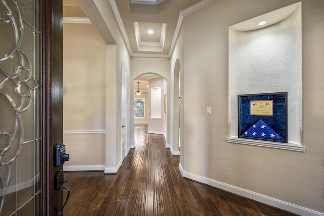 hallway with baseboards, recessed lighting, arched walkways, dark wood-style flooring, and crown molding