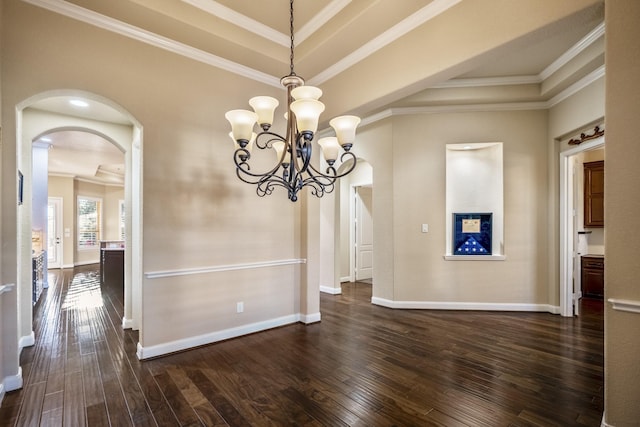 unfurnished dining area featuring arched walkways, crown molding, and dark wood-style flooring